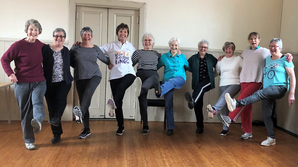 exercise group doing high kicks